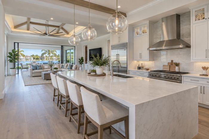 Illustrative lifestyle image of a modern kitchen with island seating and light cabinetry