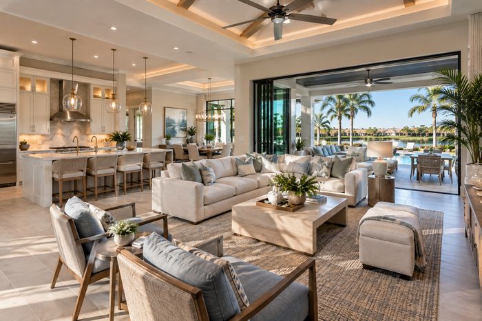 Illustrative lifestyle image of an open great room with sliding glass doors to a lanai