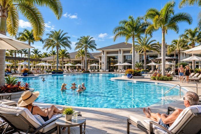 Illustrative lifestyle image of a resort style pool with cabanas and lounge chairs